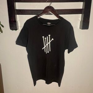 Black undefeated nail graphic tee